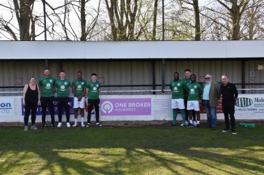 Soham-Town-Rangers-with-One-Broker's-Carly-Nineham-and-Shaun-Lenton-in-front-of-board